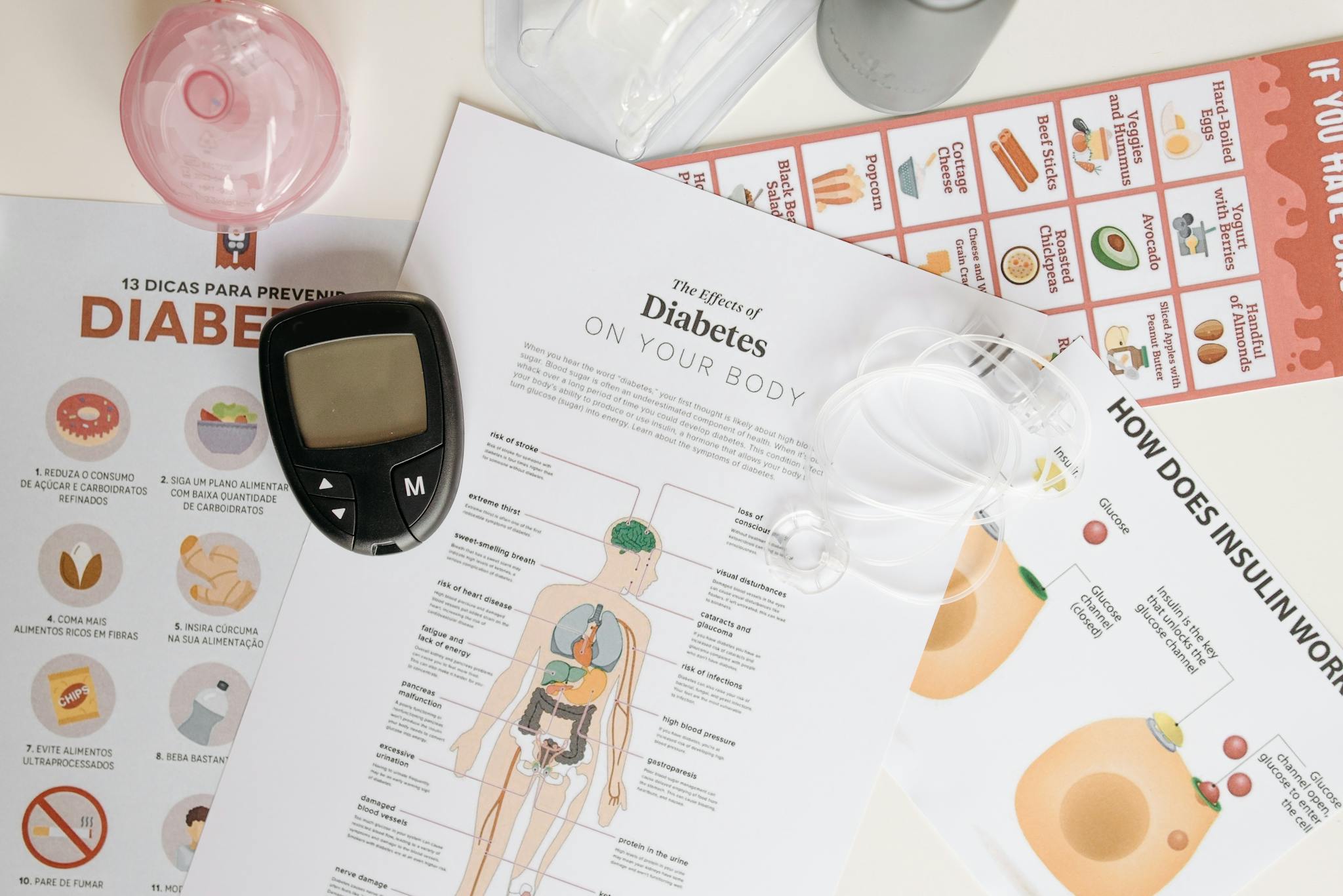 Close-up of diabetes management tools and informational documents on a table.